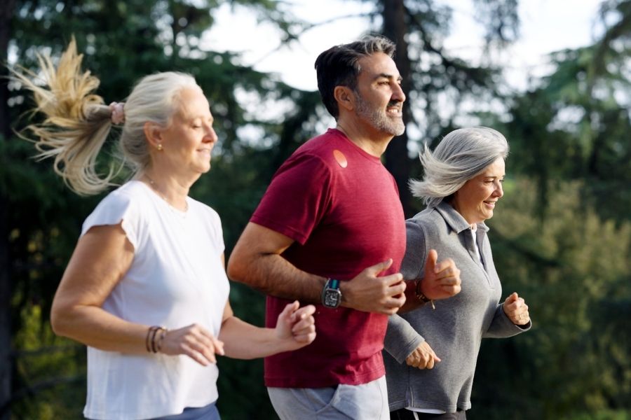 Adults engaged in outdoor movement, representing physical comfort as a result of functional bodily balance.